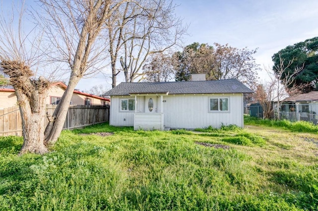 back of house featuring fence