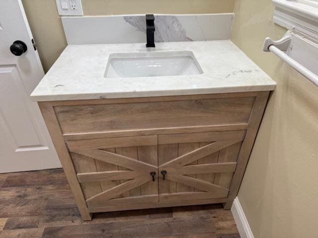 room details with vanity and wood finished floors