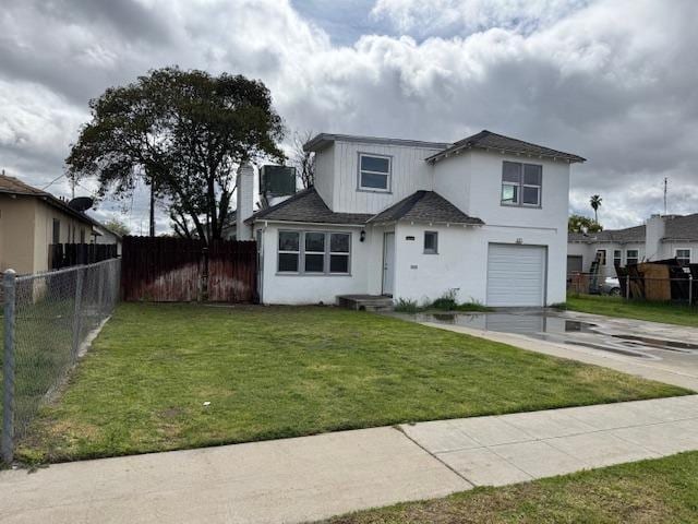 view of front facade featuring a front yard, fence, an attached garage, stucco siding, and concrete driveway