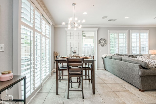 dining room featuring crown molding, light tile patterned flooring, visible vents, and a wealth of natural light