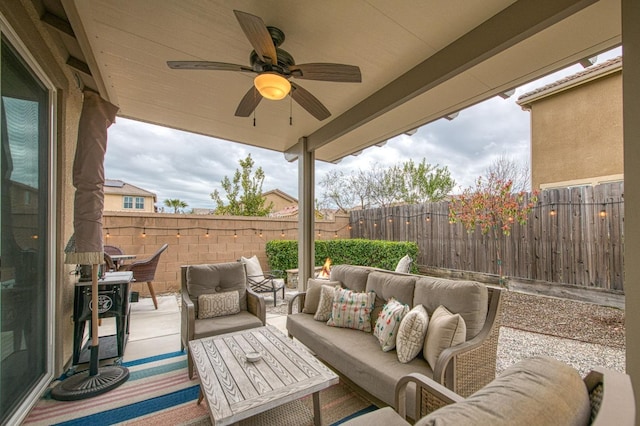 view of patio / terrace featuring an outdoor living space, a ceiling fan, and fence