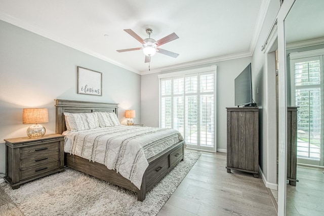 bedroom with baseboards, a ceiling fan, light wood-style flooring, and crown molding