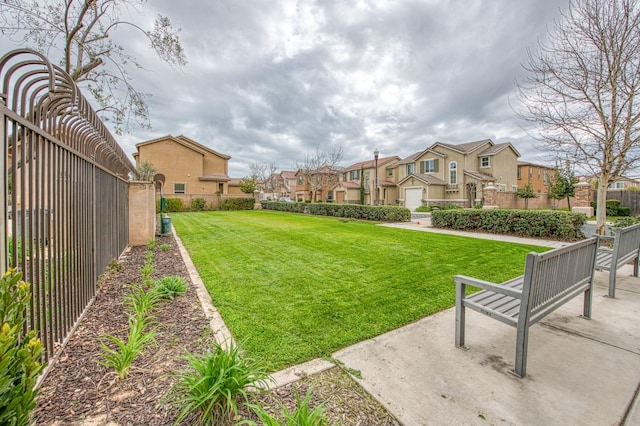 view of yard with a residential view and fence