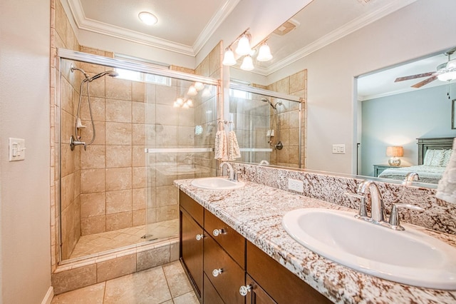 bathroom featuring ornamental molding, a stall shower, and a sink