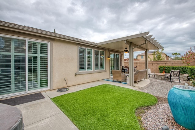 exterior space with stucco siding, a pergola, an outdoor living space, fence, and a patio area