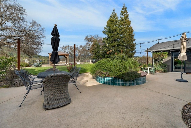 view of patio featuring a gazebo and outdoor dining area