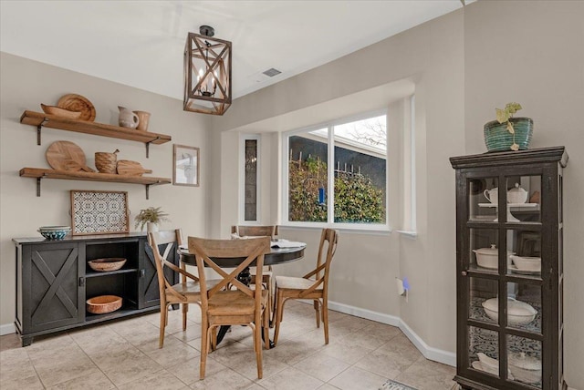 dining space featuring light tile patterned floors, baseboards, and visible vents