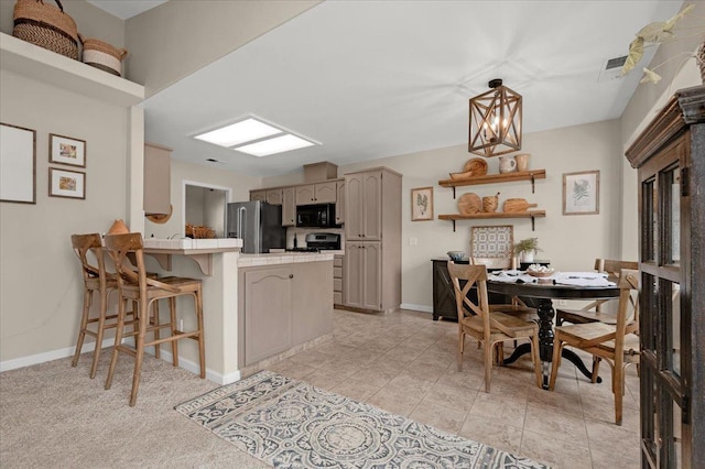 interior space featuring a breakfast bar area, baseboards, a peninsula, stainless steel fridge with ice dispenser, and black microwave