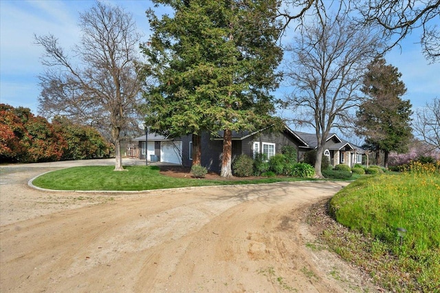 view of front of home featuring curved driveway