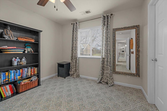 interior space featuring a ceiling fan, visible vents, carpet floors, and baseboards