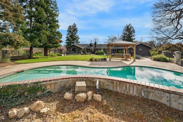 view of swimming pool featuring fence, a gazebo, outdoor lounge area, a yard, and a patio area