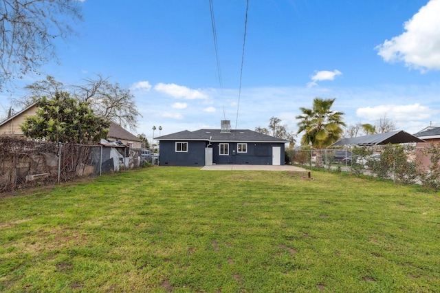 rear view of property featuring a patio area, a yard, a fenced backyard, and stucco siding