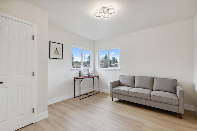 living area with baseboards and light wood finished floors