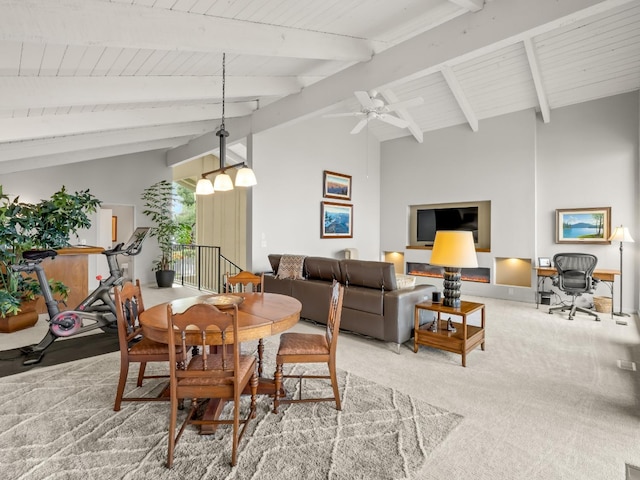 carpeted dining room featuring beamed ceiling, high vaulted ceiling, and a ceiling fan