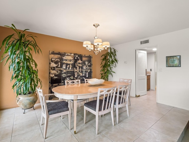 dining area featuring a notable chandelier, visible vents, baseboards, and light tile patterned floors