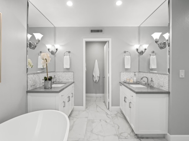 bathroom featuring a sink, visible vents, tasteful backsplash, and marble finish floor