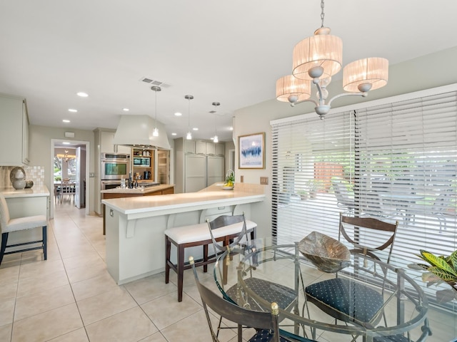 dining area featuring light tile patterned flooring, a notable chandelier, recessed lighting, and visible vents