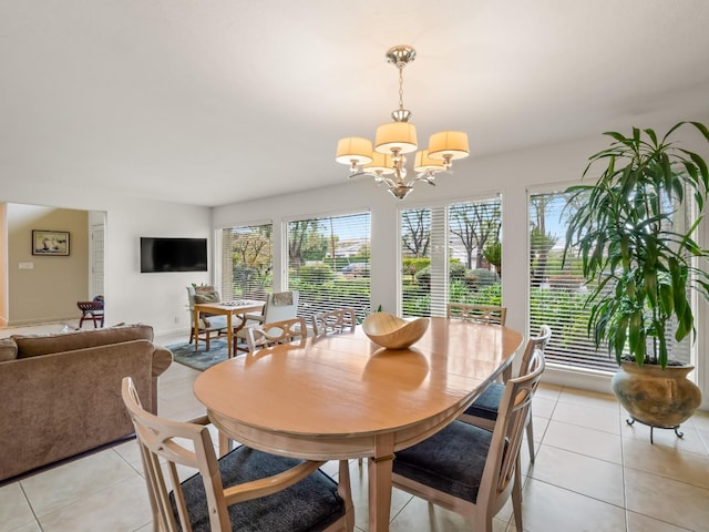 dining space with light tile patterned floors and a notable chandelier