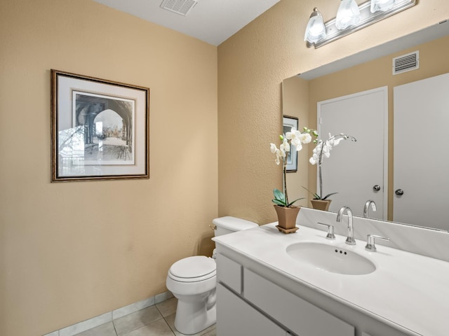 bathroom featuring visible vents, toilet, vanity, and tile patterned flooring