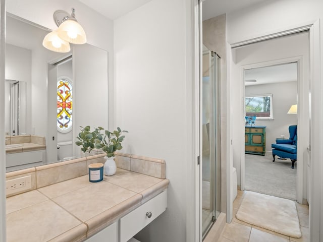 bathroom featuring vanity, toilet, a stall shower, and tile patterned flooring