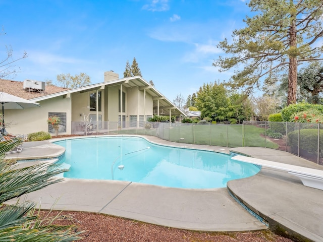 view of swimming pool with a patio area, fence, and a fenced in pool