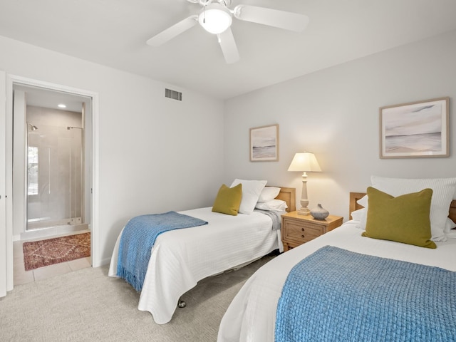 bedroom featuring visible vents, carpet floors, ensuite bath, ceiling fan, and tile patterned flooring