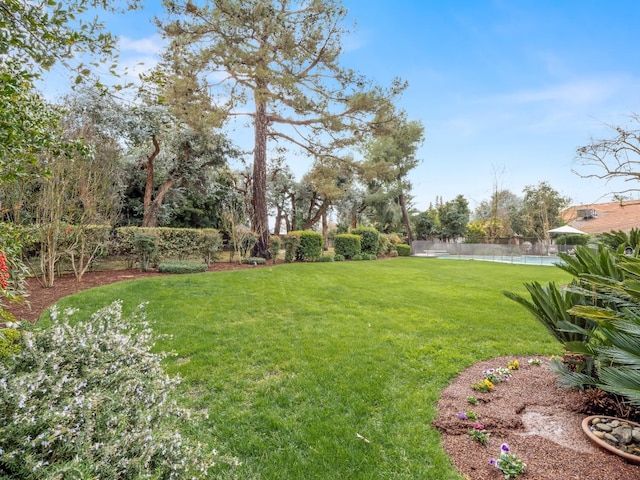 view of yard featuring a water view and fence