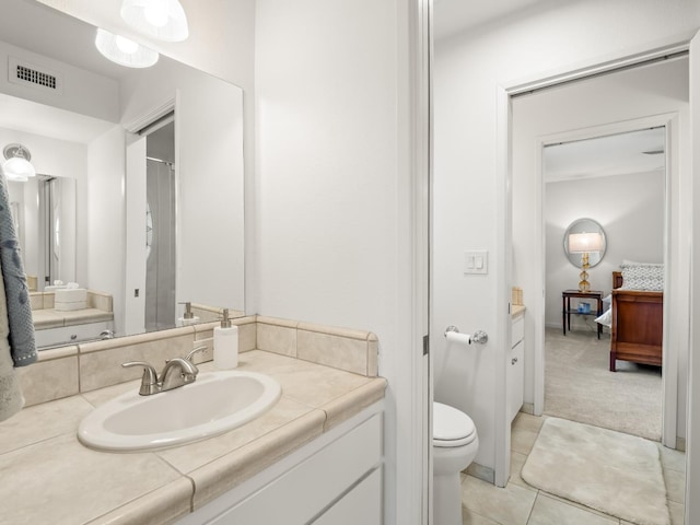 bathroom featuring tile patterned flooring, visible vents, toilet, and vanity