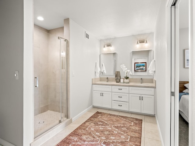 full bath featuring tile patterned flooring, a shower stall, double vanity, and a sink