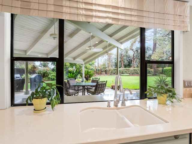 interior space featuring area for grilling, outdoor dining area, ceiling fan, and a sink