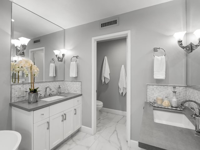 bathroom featuring tasteful backsplash, visible vents, baseboards, marble finish floor, and vanity