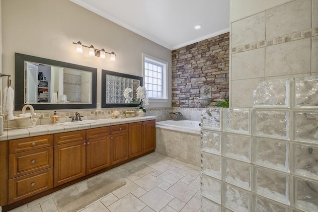 bathroom with vanity, crown molding, and a garden tub