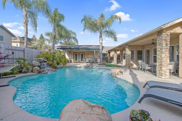 view of swimming pool featuring a ceiling fan, a patio, fence, and a fenced in pool