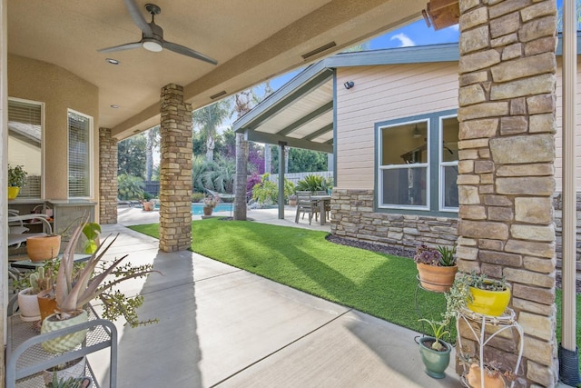 view of patio featuring a ceiling fan and fence