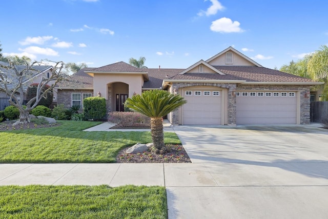 view of front of house featuring an attached garage, a front lawn, stucco siding, stone siding, and driveway