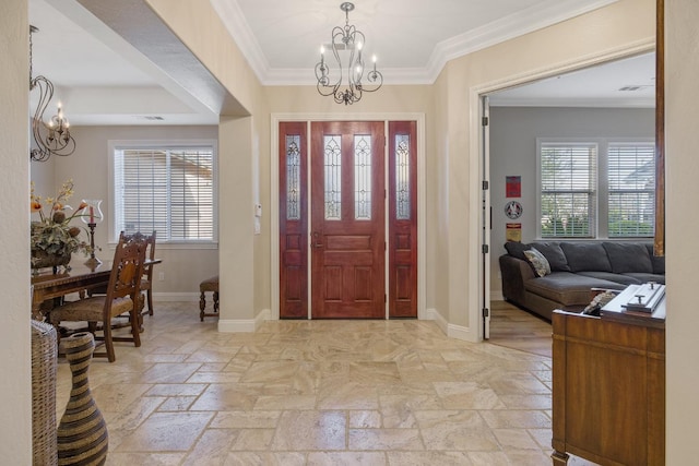 entryway with a chandelier, baseboards, crown molding, and a wealth of natural light