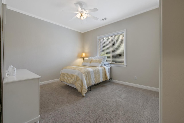 bedroom featuring a ceiling fan, baseboards, visible vents, crown molding, and light colored carpet