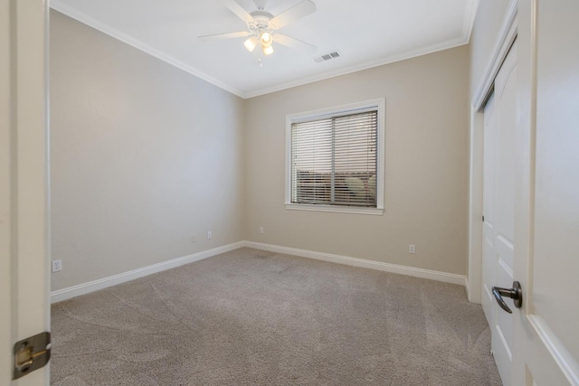 unfurnished bedroom with visible vents, carpet floors, baseboards, and ornamental molding