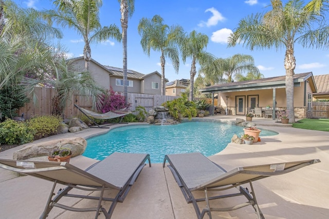 view of swimming pool with a patio area, a fenced in pool, and a fenced backyard