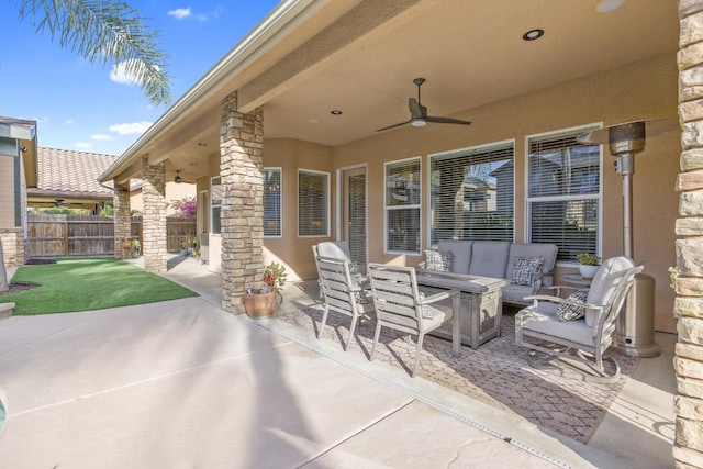 view of patio / terrace featuring an outdoor hangout area, fence, and ceiling fan