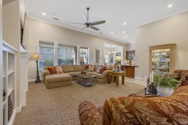 living room featuring visible vents, baseboards, ornamental molding, and ceiling fan with notable chandelier