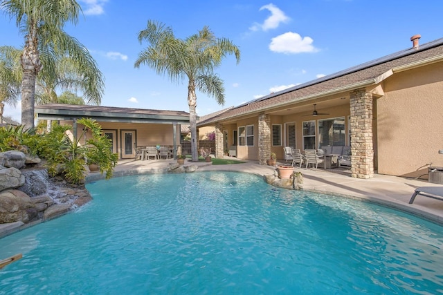 outdoor pool with a patio, outdoor dining area, and ceiling fan