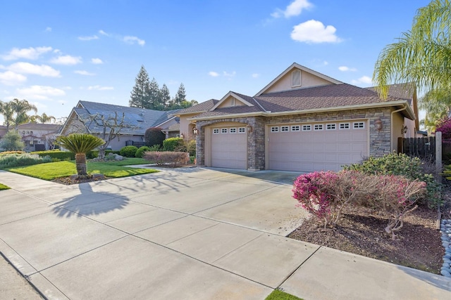 ranch-style home with fence, driveway, an attached garage, stucco siding, and stone siding