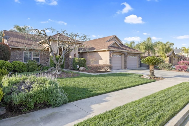 view of front of property with concrete driveway, a front yard, stucco siding, stone siding, and an attached garage