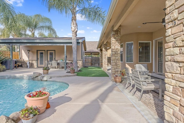 view of pool with a patio area, fence, and a fenced in pool