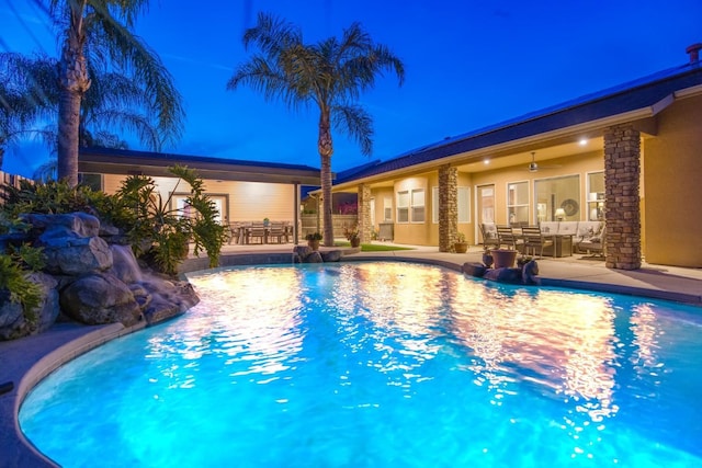 pool with outdoor dining area, ceiling fan, and a patio area