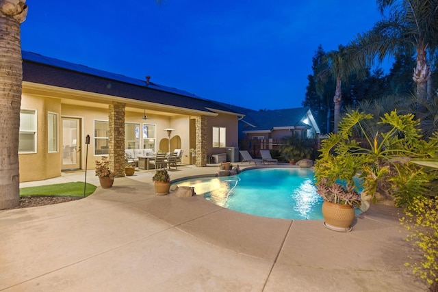 outdoor pool featuring a patio area and fence