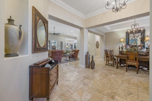 interior space featuring stone tile flooring, ceiling fan with notable chandelier, baseboards, and ornamental molding