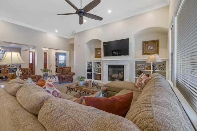 living room featuring recessed lighting, a glass covered fireplace, a ceiling fan, and crown molding