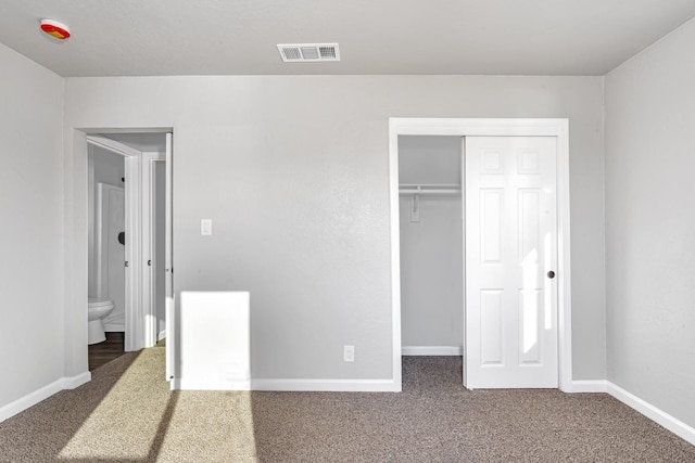 unfurnished bedroom featuring a closet, visible vents, baseboards, and carpet floors